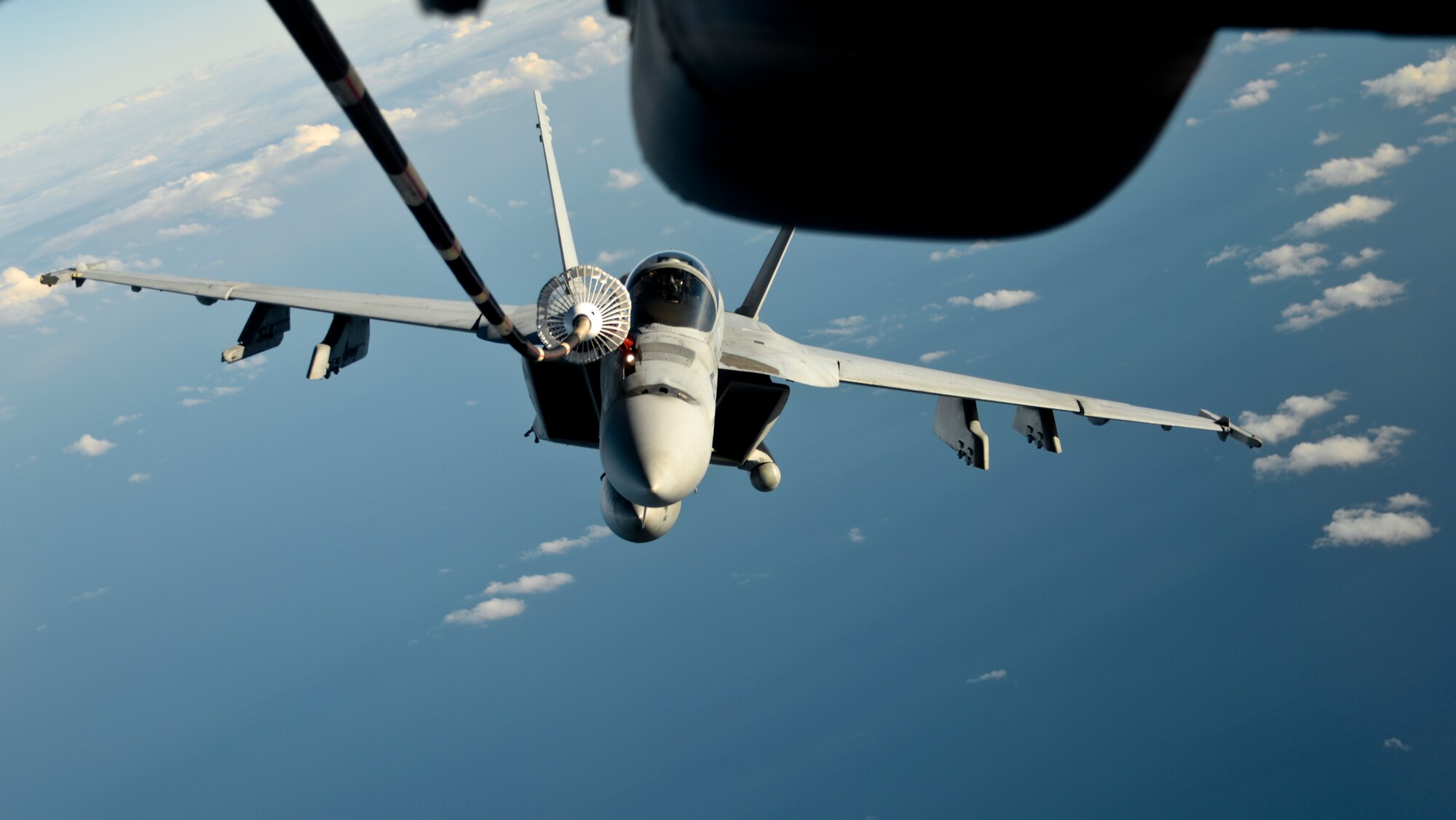 A KC-10 Extender from Travis Air Force Base, California, refuels a U.S. Navy F/A-18 Super Hornet over the Pacific Ocean July 14, 2017. KC-10s from Travis AFB supported Exercise Talisman Saber 2017 by conducting various air refueling missions over Australia. TS17 is a biennial exercise in Australia that focuses on bilateral military training between U.S. Pacific Command forces and the Australian Defence Force to improve U.S.-Australia combat readiness, increase interoperability, maximize combined training opportunities and conduct maritime prepositioning and logistics operations in the Pacific. (U.S. Air Force photo by 2nd Lt. Sarah Johnson)