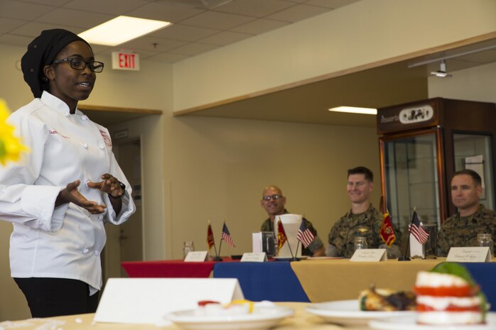 U.S. Marine Corps Sgt. Ayesha L. Zantt, a food service specialist with Headquarters and Headquarters Squadron (H&HS), talks about a meal she prepared for the Food Service Specialist of the Quarter competition at Marine Corps Air Station Iwakuni, Japan, July 13, 2017. The event prepared Marines for a larger competition July 26-27 in Okinawa.Zantt answered questions the judges had about her food and the flavors she used in each of her recipes. (U.S. Marine Corps photo by Lance Cpl. Gabriela Garcia-Herrera)
