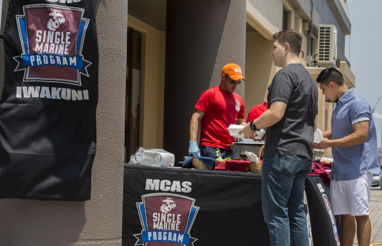 Marine Corps Air Station (MCAS) Iwakuni residents eat food provided during the Single Marine Program’s Marine Lounge grand opening at MCAS Iwakuni, Japan, July 14, 2017. Originally located on the second floor over Crossroads Mall, the Marine Lounge was moved to make it more available to single and unaccompanied service members on the air station. During the event, people participated in a video game tournament, sumo tournament, karaoke contest, watched a movie marathon and took part in other amenities the lounge offered. (U.S. Marine Corps photo by Lance Cpl. Gabriela Garcia-Herrera)