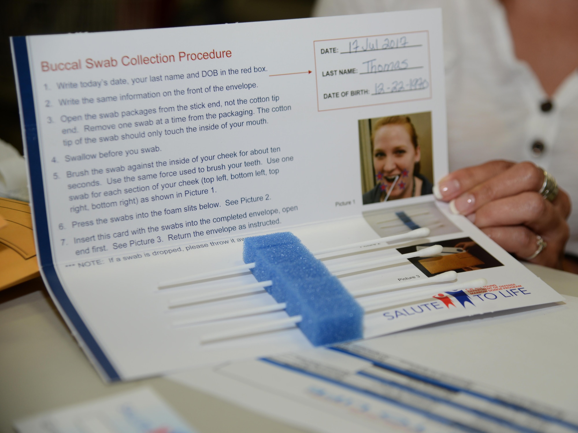 Ms. Dorothy Thomas, 47th Force Support Squadron chief of unit training, displays the swabs used for her registration during the “Salute to Bone Marrow Donor Registration Fair” at Laughlin Air Force Base, Tx., July 17, 2017. To register, participants are required to fill out a consent form and complete four cheek swabs. (U.S. Air Force photo/Airman 1st Class Benjamin N. Valmoja)
