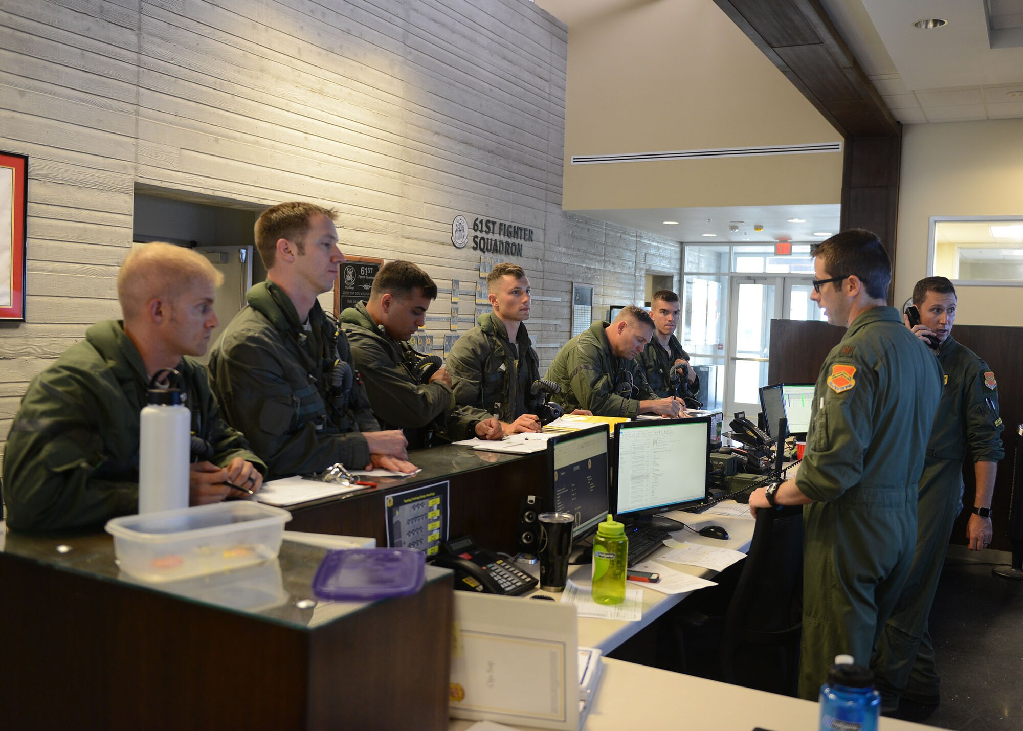 Maj. Christopher Morrison, 61st Fighter Squadron F-35A Lightning II pilot, briefs pilots on flight conditions prior to their flight at Luke Air Force Base, Ariz., July 17, 2017. This flight was the capstone flight for the first F-35A basic course students at Luke. (U.S. Air Force photo/Senior Airman James Hensley)