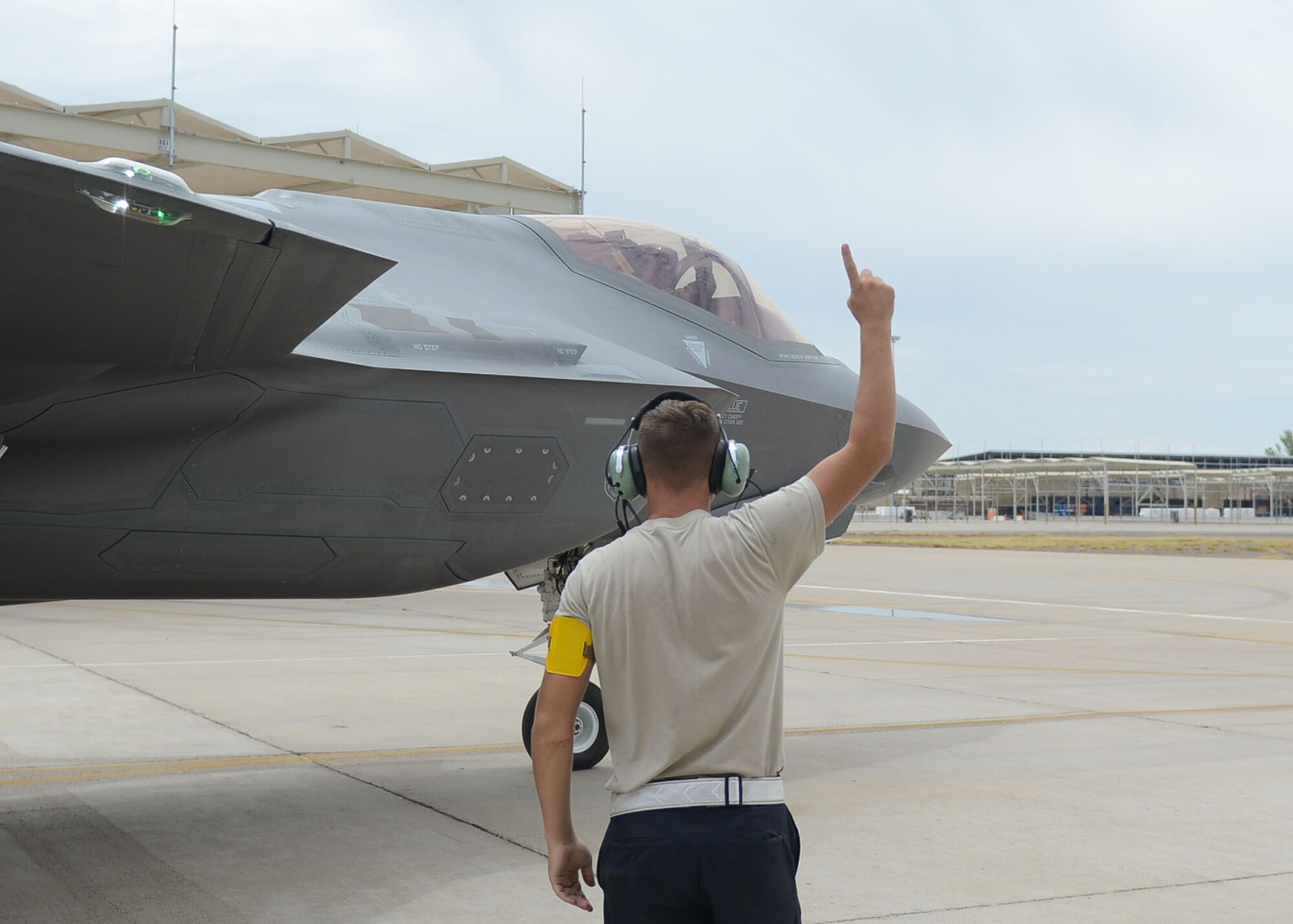 Airman Dalton Woods, 61st Aircraft Maintenance Unit crew chief, sends off 1st Lt. Jeff Teufel, 61st Fighter Squadron basic course student, at Luke Air Force Base, Ariz., July 17, 2017. Woods launched and assisted with recovery of Teufel’s aircraft ensuring his safety during his capstone flight. (U.S. Air Force photo/Senior Airman James Hensley)