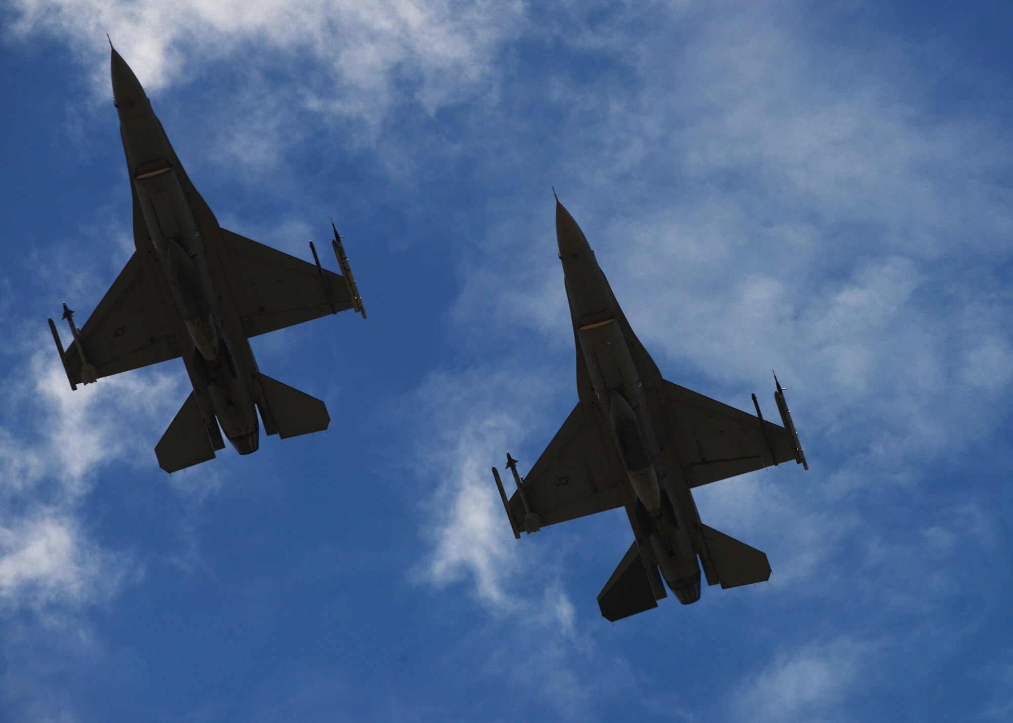 F-16 Fighting Falcons soar through the sky at Luke Air Force Base, Ariz., July 17, 2017. This flight was the capstone flight in which F-35 basic course students faced off against F-16s in a simulated combat environment. (U.S. Air Force photo/Airman 1st Class Caleb Worpel)