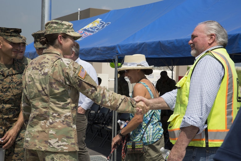 U.S. Capt. Monika Jones, branch chief, Iwakuni Veterinary Services, Public Health Activity Japan, shakes hands with guests during the opening of the veterinary clinic at Marine Corps Air Station Iwakuni, July 13, 2017. The new facility was built to accommodate the growing number of patients and military working dogs on the air station. The veterinary clinic is responsible for the welfare of hundreds of military pets and military working dogs and the new facility allows technicians to double the amount of patients they can see. (U.S. Marine Corps photo by Sgt. N.W. Huertas)