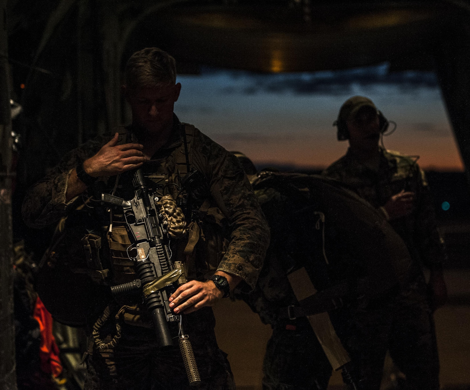 A U.S. Marine Corps 3rd Reconnaissance Battalion jumpmaster secures his weapon prior to high altitude, high opening (HAHO) jump operations from a U.S. Air Force 17th Special Operations Squadron MC-130J Commando II July 11, 2017, at Rockhampton, Australia. The U.S. Air Force 320th Special Tactics Squadron combat controllers executed multiple high altitude, low opening (HALO) and HAHO jumps with their Marine Corps partners during Talisman Saber 2017. (U.S. Air Force photo by Capt. Jessica Tait)
