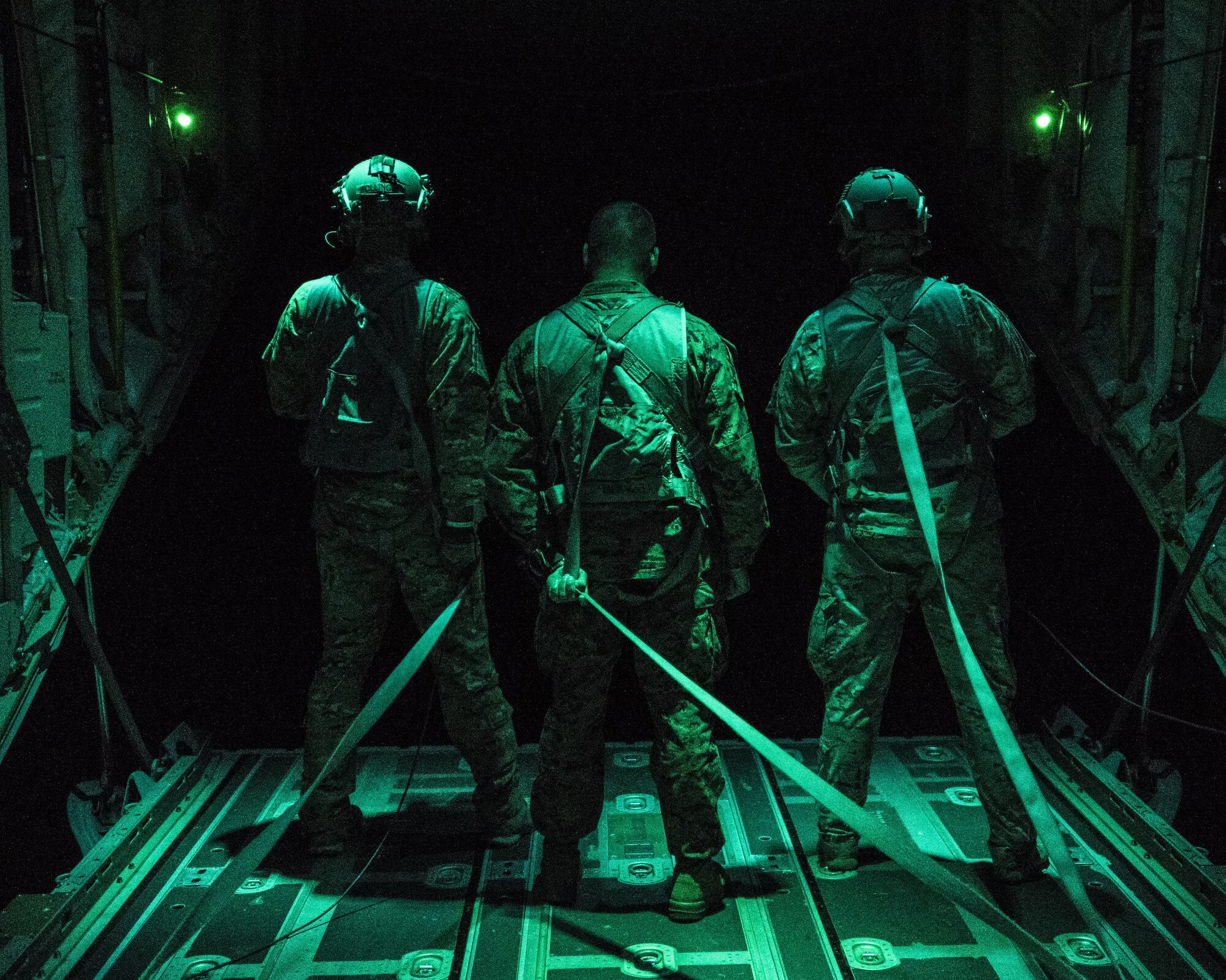 U.S. Air Force 17th Special Operations Squadron MC-130J Commando II loadmasters and a U.S. Marine Corps 3rd Reconnaissance Battalion operator look out the back of the Commando II following high altitude, high opening (HAHO) jump operations July 11, 2017, over Shoalwater Bay Training Area in Queensland, Australia during Talisman Saber 2017. The training exercise conducted between the U.S. Air Force and Marine Corps strengthens joint interoperability and working relationship between the armed services. (U.S. Air Force photo by Capt. Jessica Tait)