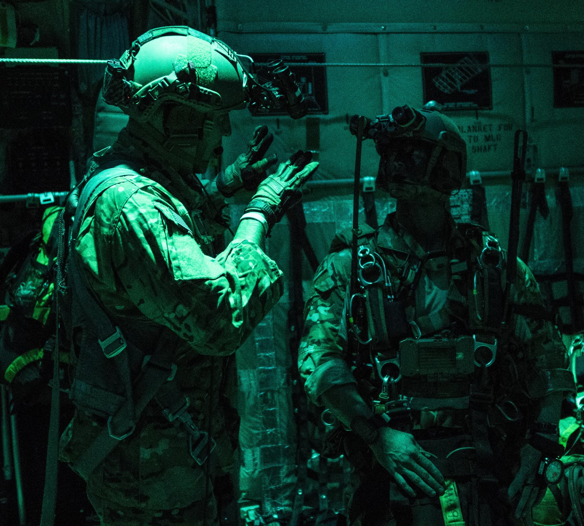 A U.S. Air Force 17th Special Operations Squadron MC-130J Commando II loadmaster and 320th Special Tactics Squadron jumpmaster discuss the time prior to high altitude, high opening (HAHO) jump operations July 11, 2017, over Shoalwater Bay Training Area in Queensland, Australia. Talisman Saber 2017 provides the relevant training necessary to maintain regional security, peace and stability. (U.S. Air Force photo by Capt. Jessica Tait)