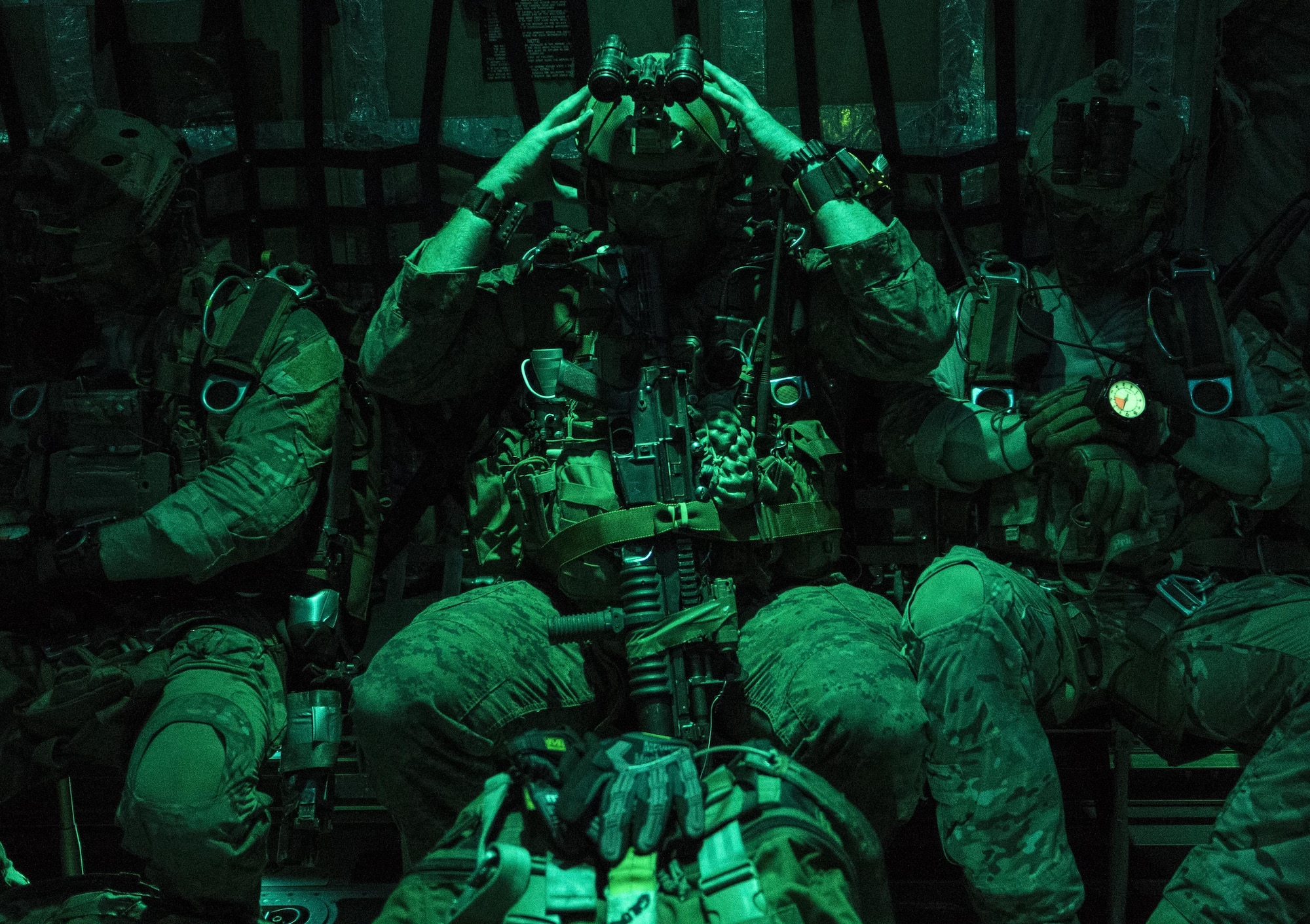 A U.S. Marine Corps 3rd Reconnaissance Battalion jumpmaster puts on his helmet on in preparation for high altitude, high opening (HAHO) jump operations July 11, 2017, over Shoalwater Bay Training Area in Queensland, Australia during Talisman Saber 2017. The training exercise conducted between the U.S. Air Force and Marine Corps strengthens joint interoperability and working relationship between the armed services. (U.S. Air Force photo by Capt. Jessica Tait)