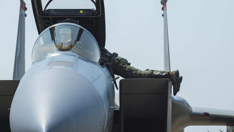 A U.S. Air Force F-15C Eagle pilot reaches into the cockpit after arriving at Misawa Air Base, Japan, June 7, 2017. Pilots and maintainers relocated from Kadena Air Base, Japan, to Misawa to conduct joint and bilateral operations with F-16 Fighting Falcons and the Japan Air Self-Defense Force’s F-2s. (U.S. Air Force photo by Staff Sgt. Deana Heitzman)
