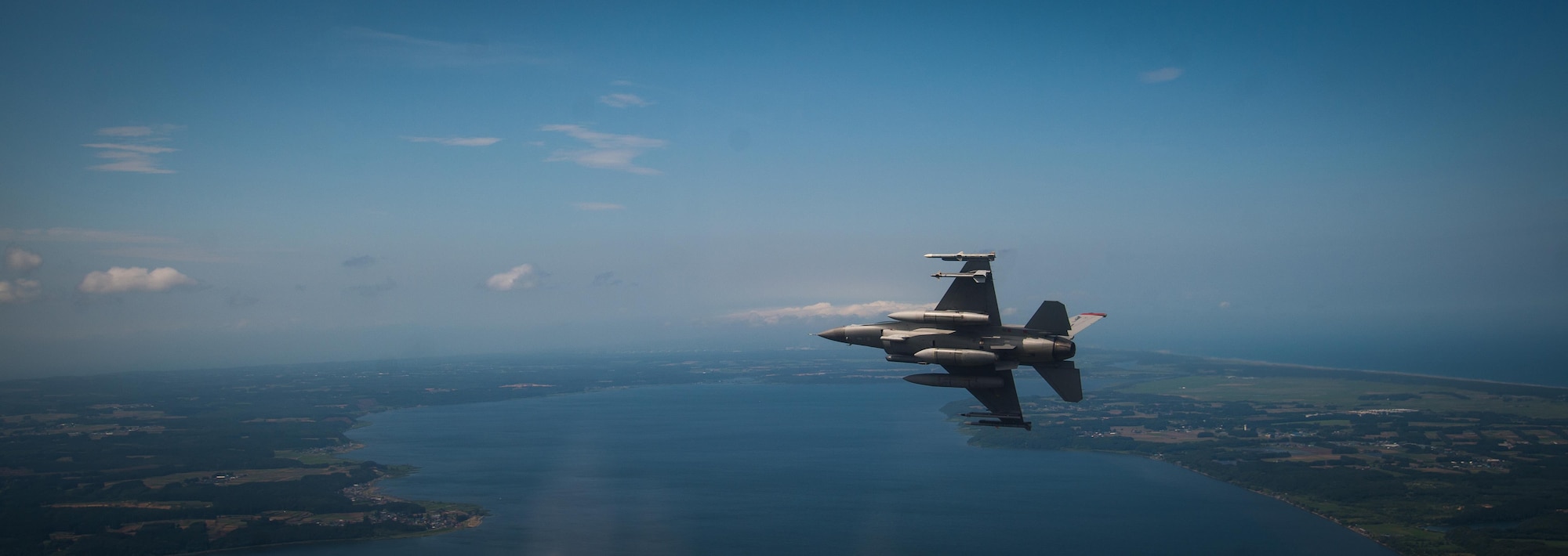 U.S. Air Force Capt. David Neville, a 13th Fighter Squadron F-16 Fighting Falcon pilot, banks right during a flight across Northern Japan, June 12, 2017. Neville and other 13th and 14th Fighter Squadron pilots joined Kadena Air Base, Japan, F-15C Eagle pilots to conduct air-to-air coverage and suppression of enemy air defense procedures during an aviation relocation training. (U.S. Air Force photo by Staff Sgt. Deana Heitzman)