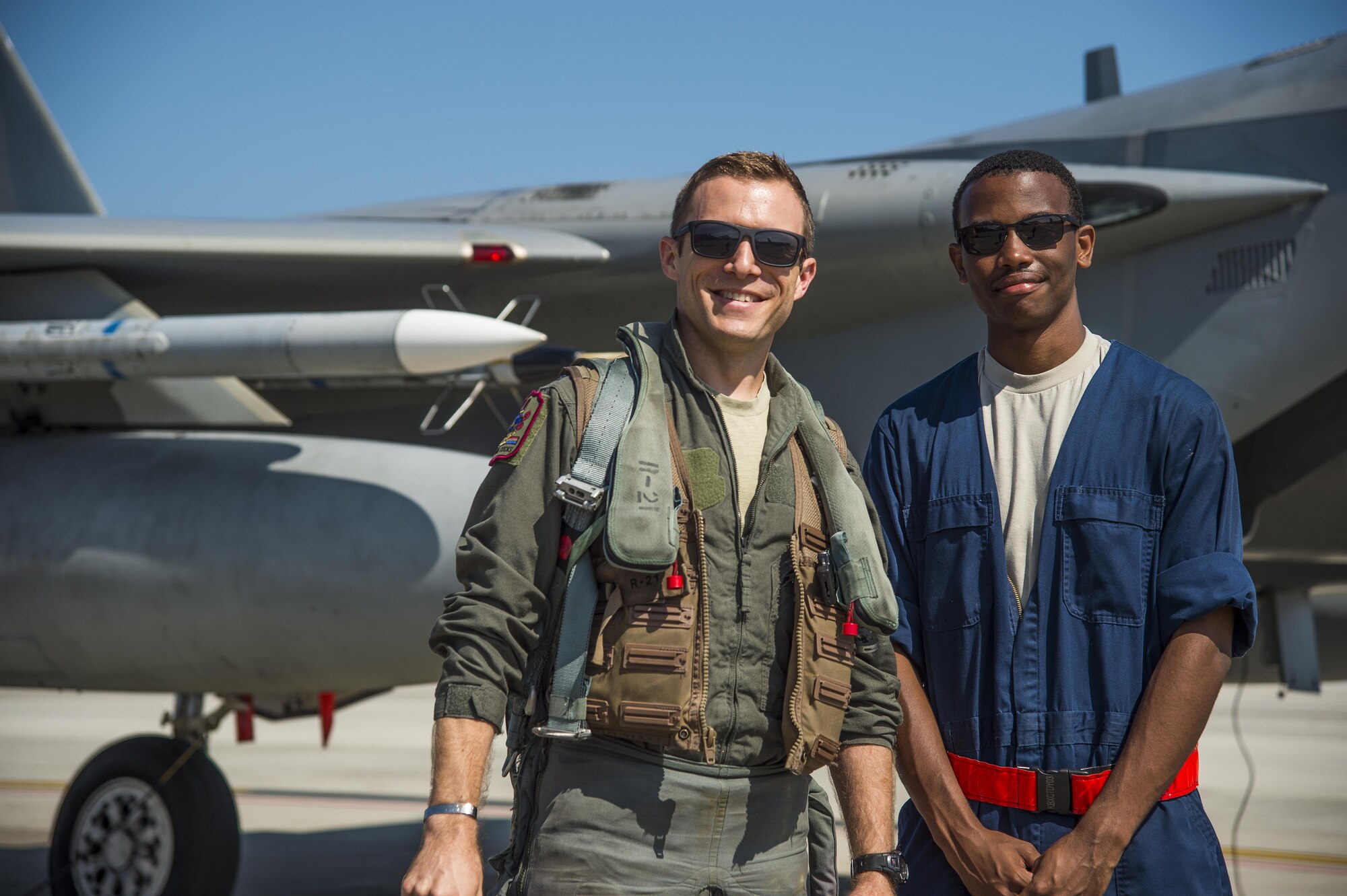 U.S. Air Force Capt. David Kuhn, left, a 67th Fighter Squadron F-15C Eagle pilot, and Senior Airman Devin Ross, right, an 18th Aircraft Maintenance Squadron crew chief, pause for a photo prior to flight at Misawa Air Base, Japan, June 13, 2017. Pilots and maintainers from Kadena AB, Japan, relocated to Misawa AB, due to its strategic location, ensuring contingency operations for airframes and units forward deployed across the Indo-Asia-Pacific region. (U.S. Air Force photo by Staff Sgt. Deana Heitzman)