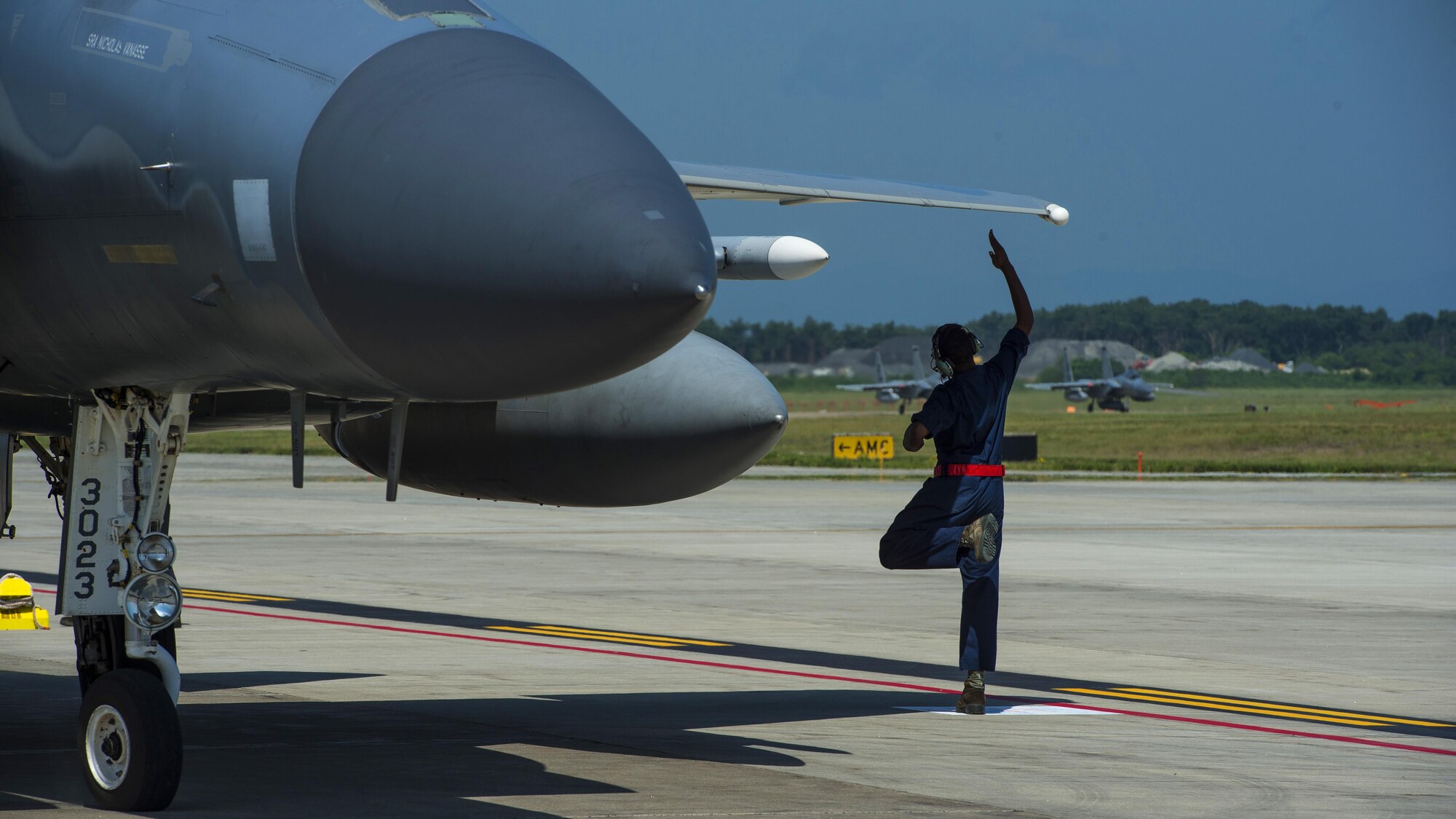 U.S. Air Force Senior Airman Devin Ross, an 18th Aircraft Maintenance Squadron crew chief, taps the wing of an F-15C Eagle prior to taxi at Misawa Air Base, Japan, June 13, 2017. Airmen and pilots from Kadena Air Base, Japan, and the 35th Fighter Wing, worked closely with Japan Air Self-Defense Force pilots to strengthen their bilateral partnership across the Indo-Asia-Pacific region. (U.S. Air Force photo by Staff Sgt. Deana Heitzman)