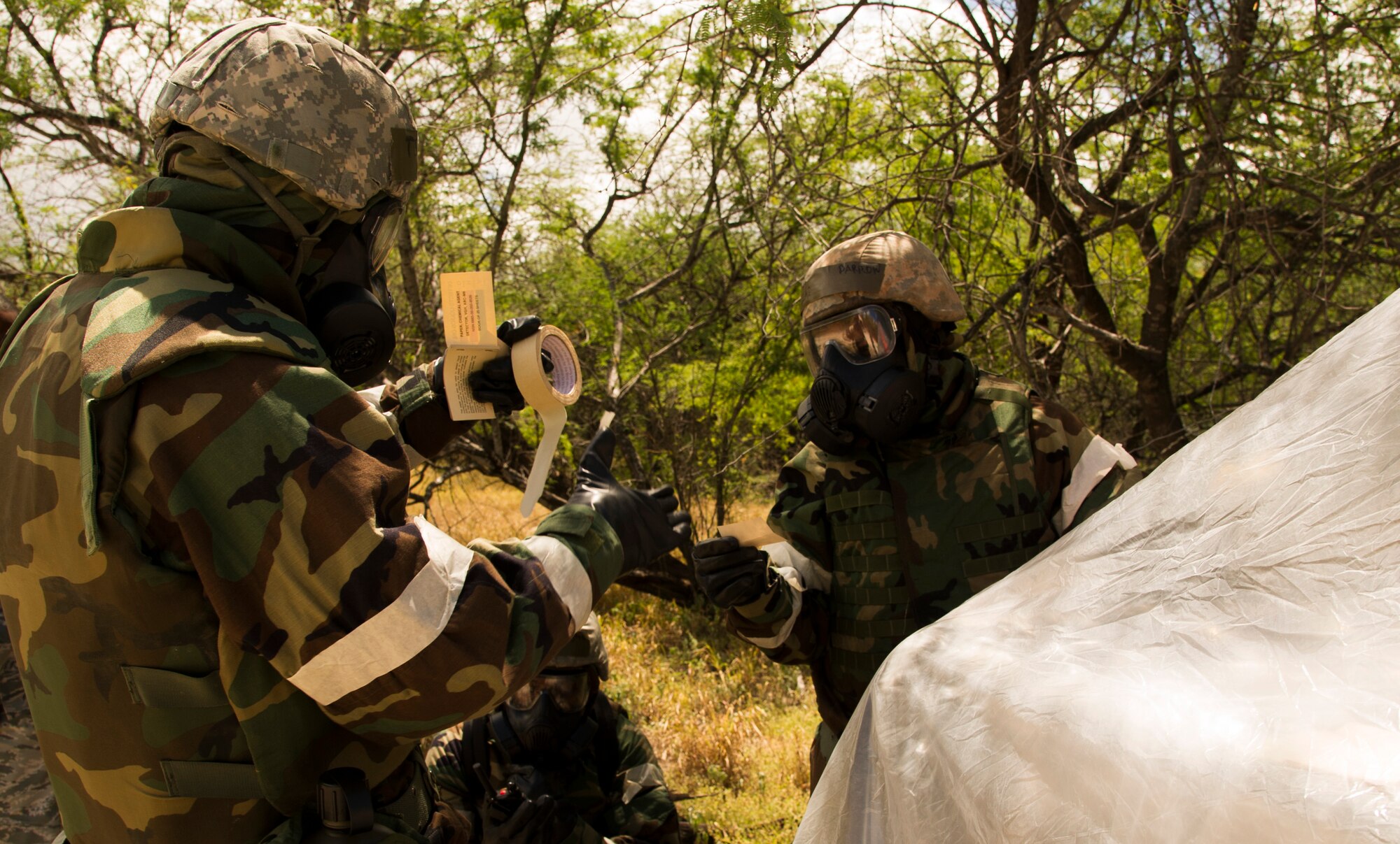 Members of the 15th Wing train on chemical, biological, radiological, and nuclear readiness during a readiness exercise, at Base X on Joint Base Pearl Harbor-Hickam, Hawaii, July 6, 2017. CBRNE training is a requirement for deployment preparation. The training teaches service members how to operate in a chemical environment. (U.S. Air Force photo by Tech. Sgt. Heather Redman)