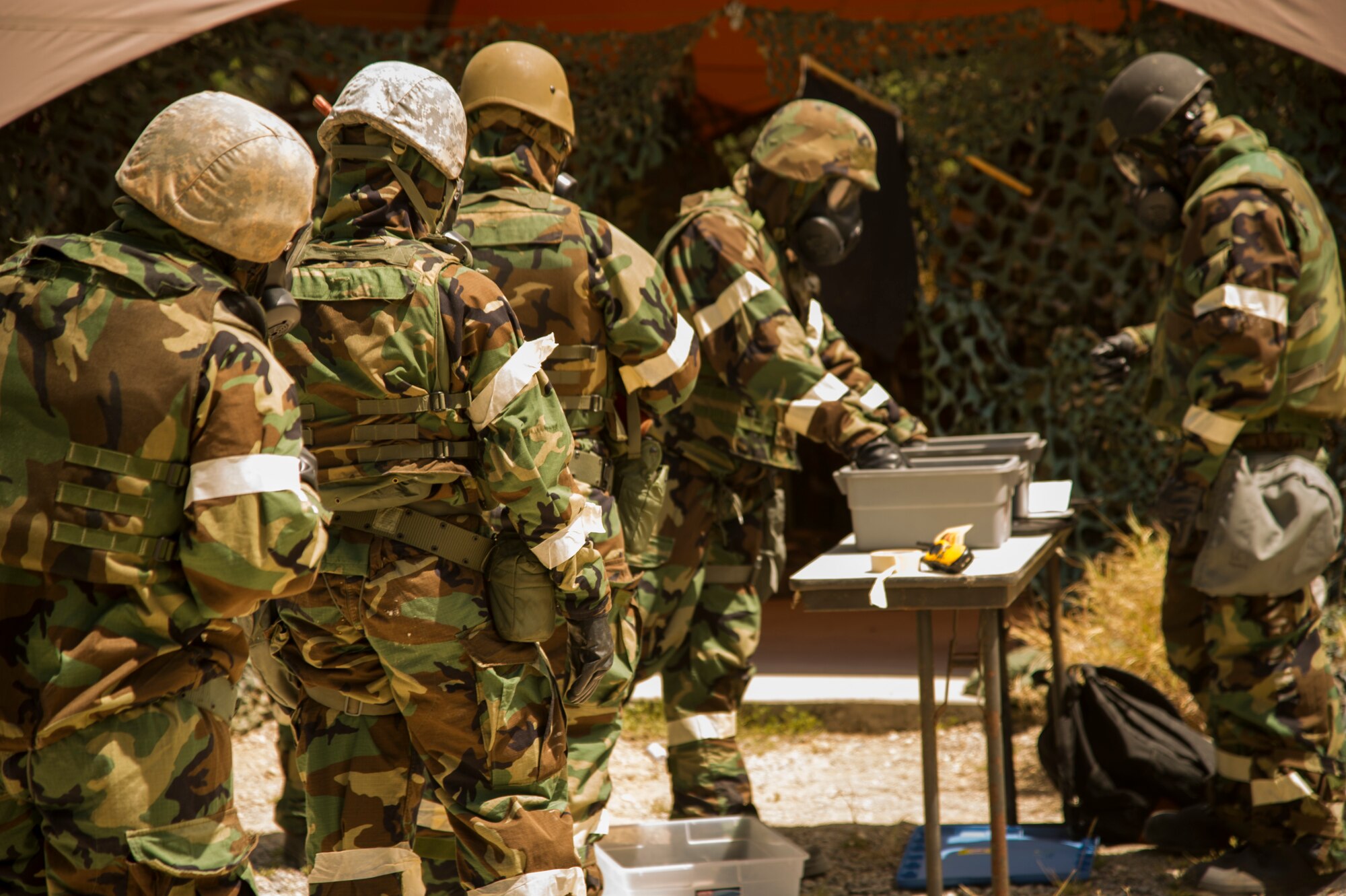 Members of the 15th Wing train on chemical, biological, radiological, and nuclear readiness during a readiness exercise, at Base X on Joint Base Pearl Harbor-Hickam, Hawaii, July 6, 2017. CBRNE training is a requirement for deployment preparation. The training teaches service members how to operate in a chemical environment. (U.S. Air Force photo by Tech. Sgt. Heather Redman)