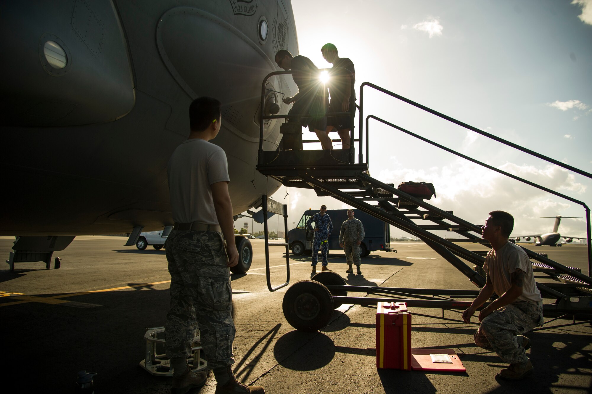 Maintainers from the 15th Maintenance Group and members from the 36th Squadron from Royal Australian Air Force Base Amberley, perform maintenance on a C-17 Globemaster on Joint Base Pearl Harbor-Hickam, Hawaii, July 12, 2017.  The Airmen came together for a week long combined Enhanced Air Cooperation training event designed to integrate maintenance capabilities between the U.S. and Australia.  (U.S. Air Force photo by Tech. Sgt. Heather Redman)