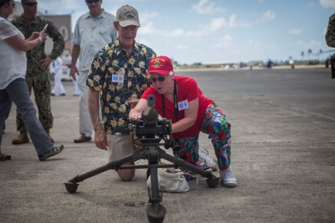 MARINE CORPS AIR STATION KANEOHE BAY - Members of John Finn’s family get familiar with a machine gun similar to the one Finn used during the attack on Pearl Harbor as part of a tour aboard Marine Corps Air Station, Kaneohe Bay. The tour allowed family members to explore the legacy left by Finn after carrying out the feats of heroism that earned himself the first Medal of Honor of WWII. (U.S. Marine Corps Photo by Cpl. Zachary Orr)
