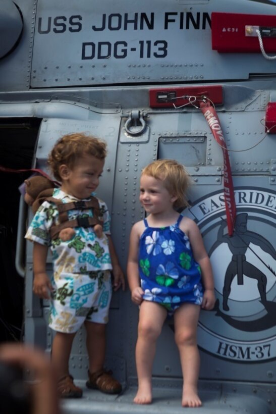 MARINE CORPS AIR STATION KANEOHE BAY - Children of John Finn’s family stand on a Super Stallion CH-53E helicopter during a tour aboard Marine Corps Base Hawaii July 14, 2017. The tour allowed family members to explore the legacy left by Finn after carrying out the feats of heroism that earned himself the first Medal of Honor of WWII. (U.S. Marine Corps Photo by Lance Cpl. Luke Kuennen)