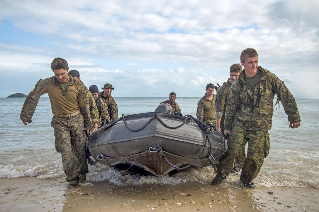 Marines carry a combat rubber raiding craft to the beach on Townshend Island, Australia, as part of a large-scale amphibious assault exercise during Talisman Saber 2017. Talisman Saber is a biennial U.S.-Australia exercise. Navy photo by Petty Officer 2nd Class Sarah Villegas 