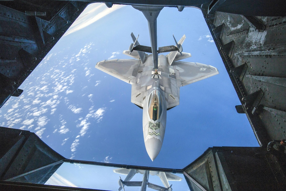 An Air Force F-22 Raptor receives fuel from a KC-10 Extender over the Atlantic Ocean, July 15, 2017. The F-22 is based at Joint Base Langley-Eustis, Va.; the K-10 is based at Joint Base McGuire-Dix-Lakehurst, N.J. Air Force photo by Master Sgt. Mark C. Olsen