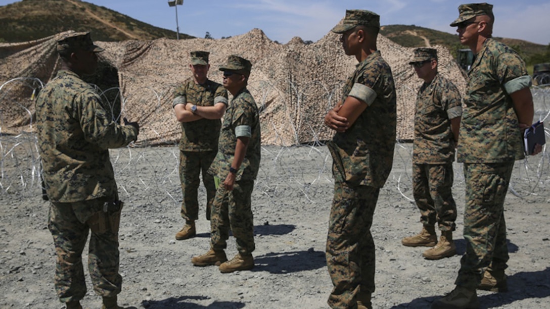 Capt. Tywan Turner, left, MTACS-38 weapons and tactics training program officer, shows the tactical air direction center to (from left to right) Col. Chris Richie, former commanding officer of Marine Air Control Group 38, Sgt. Maj. Larry B. Buenefe, sergeant major of MACG-38, Maj. Kalani Creutzburg, supply officer for MACG-38, Maj. Michal Carlson, operations officer of MACG-38, and Lt. Col. James K. McBride, Marine Tactical Air Command Squadron 38 commanding officer, at East Miramar, California, June 8. MTACS-38 conducted exercise HYDRA 1-17 to simulate ship-to-shore movement by employing a TADC and integrated with a Navy tactical air control center.
