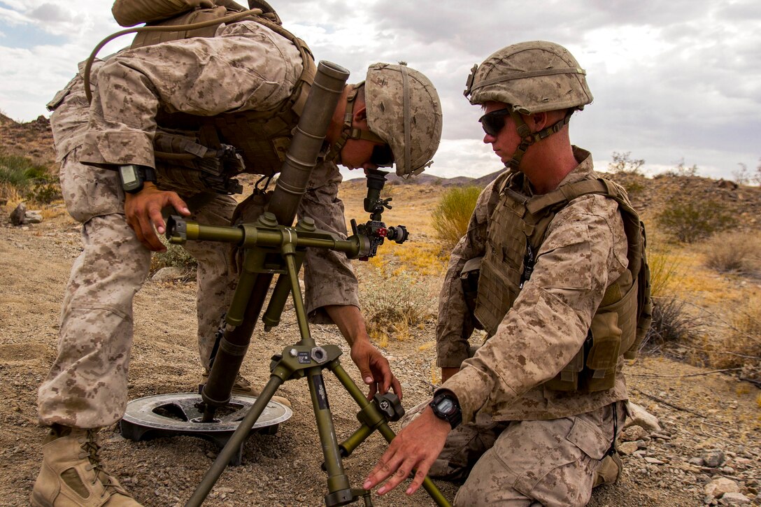 Marine Corps Lance Cpl. Anthony Alamillo and Lance Cpl. Bryan Crow practice gun drills with a mortar system during a Marine Corps Combat Readiness Evaluation at Marine Corps Air Ground Combat Center Twentynine Palms, Calif., July 8, 2017. Alamillo and Crow are mortar men assigned to the 1st Marine Division’s 2nd Battalion, 7th Marine Regiment. Marine Corps photo by Cpl. Justin Huffty