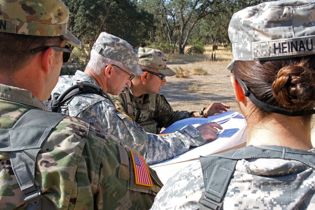 Staff Sgt. Horacio Morfin, middle right, an operations sergeant with the 149 Chemical, Biological, Radiological, Nuclear (CBRN) Company, 49th Military Police Brigade, California Army National Guard, explains possible travel routes to his company's lead Observer Controller/Trainer (OC/T) and U.S. Army Reserve Soldier, Master Sgt. Michael Nope of the 91st Training Division, 84th Training Command, during a Combat Support Training Exercise (CSTX) at Fort Hunter Liggett, Calif., July 12, 2017. OC/Ts are overseeing early 5,400 service members from the U.S. Army Reserve, U.S. Army, Army National Guard, U.S. Navy, and Canadian Armed Forces training at Fort Hunter Liggett as part of the 84th Training Command's CSTX 91-17-03; this is a unique training opportunity that allows U.S. Army Reserve units to observe, control and train alongside their multi-component and joint partners as part of the America's Army Reserve evolution into the most lethal Federal Reserve force in the history of the nation. (U.S. Army Reserve photo by Sgt. 1st Class Joy Dulen)