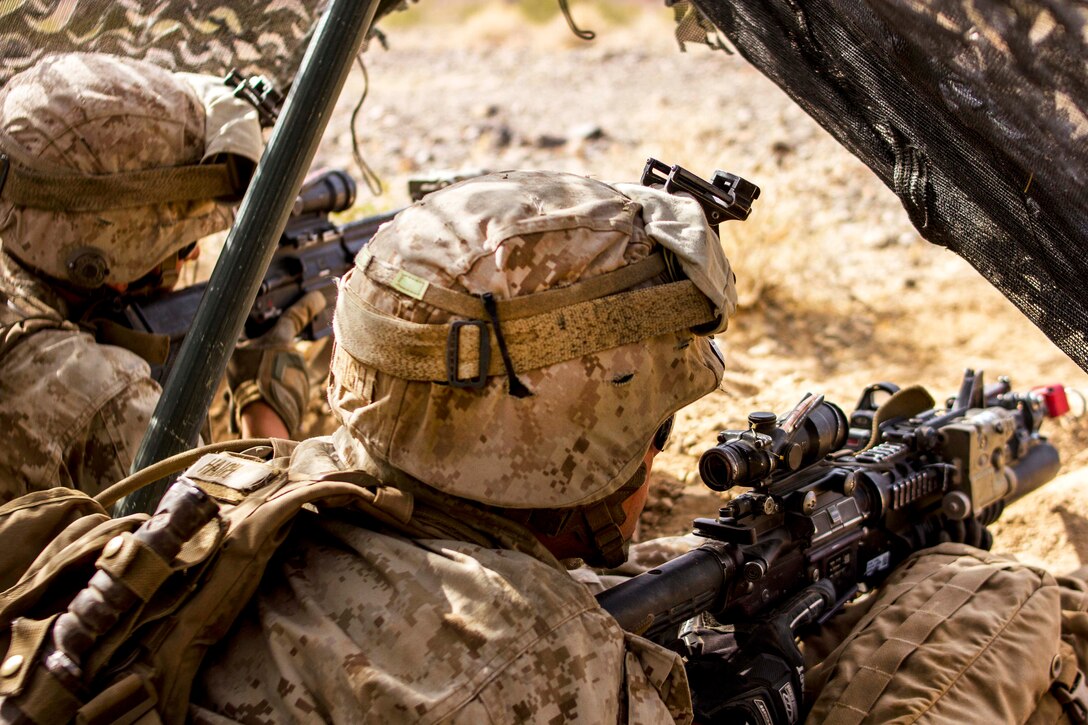 Marine Corps Lance Cpls. Martin Flores Blanks and Preston Haigh provide security from a defensive fighting position during a Marine Corps Combat Readiness Evaluation at Marine Corps Air Ground Combat Center Twentynine Palms, Calif., July 8, 2017. Blanks and Haigh are riflemen assigned to 1st Marine Division’s 2nd Battalion, 7th Marine Regiment. Marine Corps photo by Cpl. Justin Huffty