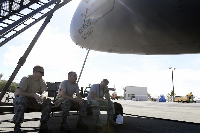 Maintainers from Joint Base MDL take a break after inspecting and refueling three KC-10 Extender aircraft following the in-flight refueling of C-17 Globemaster III en route from Alaska to Australia on Wake Island, July 11, 2017. The maintainers were responsible for ensuring the KC-10 Fleet from Joint Base MDL could successfully refuel aircraft over Wake Island in the Pacific.

