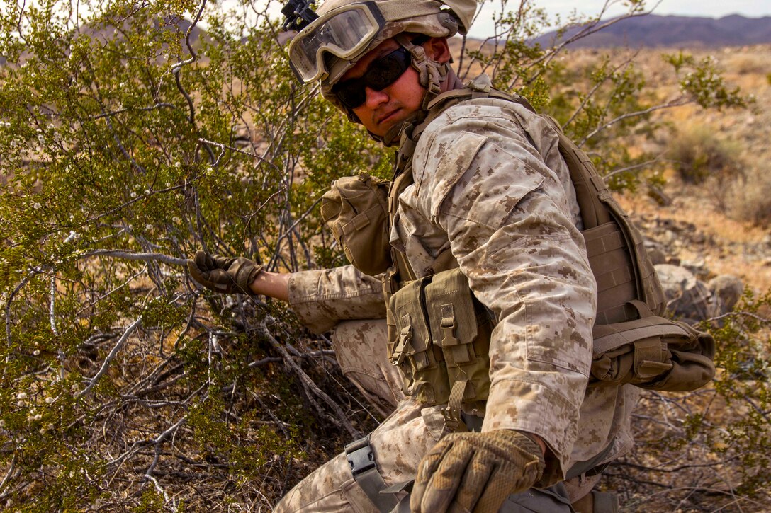 Marine Corps Sgt. Esteban Keel sets up a trip wire attached to a flare during a Marine Corps Combat Readiness Evaluation at Marine Corps Air Ground Combat Center Twentynine Palms, Calif., July 8, 2017. Keel is a rifleman assigned to the 1st Marine Division’s 2nd Battalion, 7th Marine Regiment. Marine Corps photo by Cpl. Justin Huffty