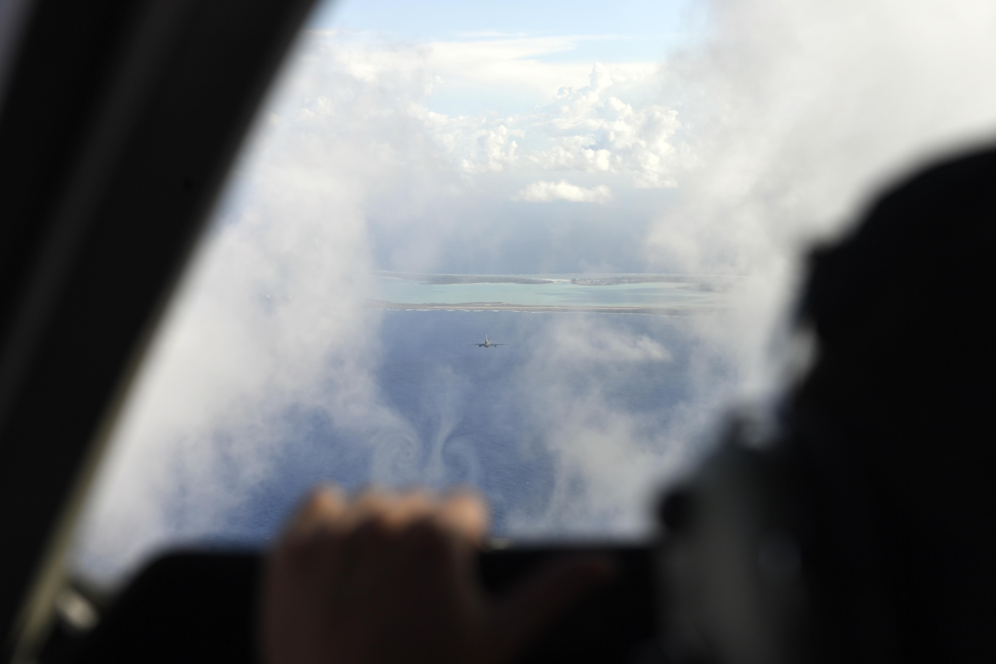 A formation of KC-10 Extender aircraft prepare to land at Wake Island after successfully offloading hundreds of thousands of pounds of fuel to C-17 Globemaster III en route from Alaska to Australia. Wake Island is an unincorporated U.S. territory in the South Pacific. 
