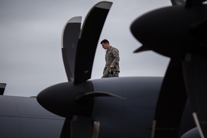 Air Force Airman 1st Class Trevor Galindo, a crew chief for the Alaska Air National Guard's 176th Maintenance Squadron, inspects the upper fuselage and checks the operational status of external lights on an HC-130J Hercules aircraft at Joint Base Elmendorf-Richardson, Alaska, June 28, 2017. Alaska Air National Guard photo by Air Force Staff Sgt. Daniel Bellerive