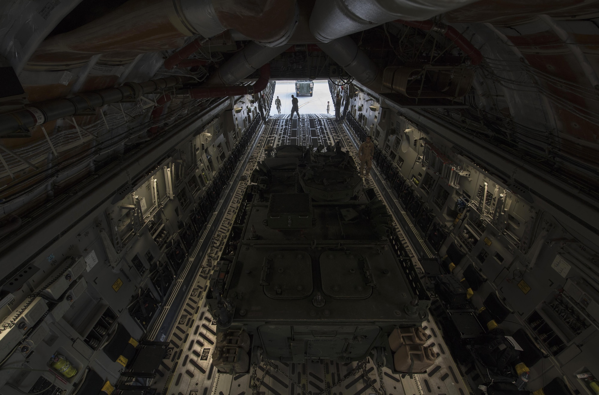 Two U.S. Army 2nd Cavalry Regiment Interim Armored Vehicle Strykers are loaded into a U.S. Air Force C-17 Globemaster III to be delivered to Bulgaria at Nuremburg Airport, Germany, July 13, 2017. Delivering Stryker vehicles to Bulgaria is an example of how assets are ready and postured to assure, deter, and respond as a joint and combined team in the event a U.S. response is required. (U.S. Air Force photo by Senior Airman Tryphena Mayhugh)