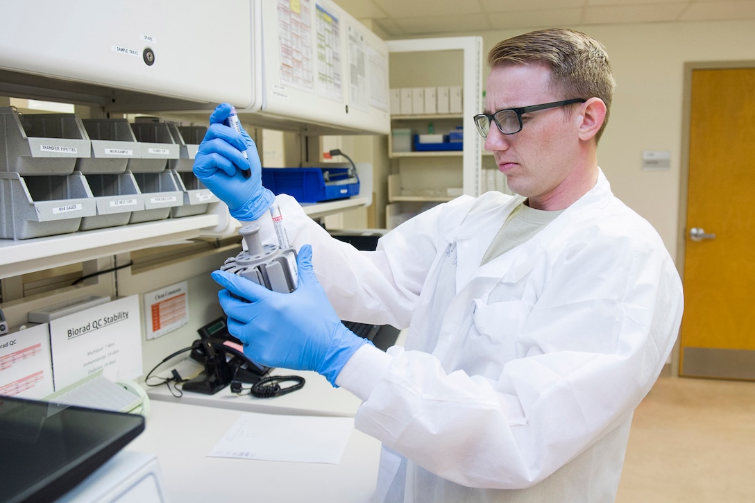 Staff Sgt. Douglas Turner, Non Commissioned Officer in Charge of laboratory services, prepares chemistry samples for analysis by placing them in the machine sample tray, July 17, 2017, at the medical clinic, Patrick Air Force Base, Fla. Lab technicians recently used the 45th Space Wing’s Continuous Process Improvement program to redesign six processing areas at the medical clinic. At a weeklong Green Belt academics course they learned new tools and techniques to use in solving problems, improving processes and creating value for patients and physicians. (U.S. Air Force photo by Phil Sunkel)