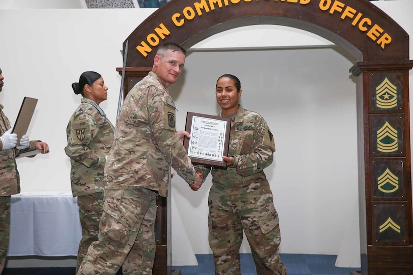 Command Sgt. Maj. Larry D. Godsey, 1st Battalion, 138th Infantry Regiment, Missouri Army National Guard, presents Sgt. Marlene Vazquez, 3rd Medical Command-Deployment Support, with a noncommissioned officer certificate at an NCO induction ceremony held at Camp As Sayliyah, Qatar, July 1, 2017. Thirty-eight U.S. Army Central Soldiers assigned to the 3rd Medical Command-Deployment Support, 1st Theater Sustainment Command, and the Missouri Army National Guard’s 1st Bn, 138 Inf. Regt. participated in the ceremony.  (U.S. Army photo by Vincent Cummings)