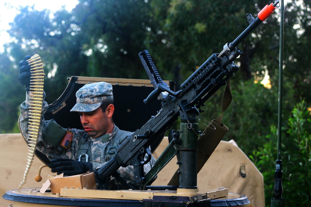 Army Sgt. Jeancarlo Galindo loads a M240B machine gun while preparing to go out on patrol during exercise Talisman Saber at Shoalwater Bay, Queensland, Australia, July 15, 2017. Galindo is a team leader assigned to Fox Company, 427th Brigade Support Battalion of the New York Army National Guard. Army National Guard photo by Sgt. Alexander Rector