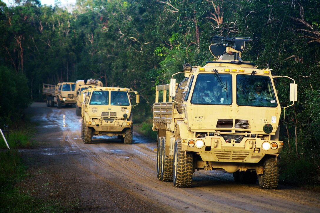 Light medium tactical vehicles leave Camp Samuel Hill during exercise Talisman Saber at Shoalwater Bay, Queensland, Australia, July 15, 2017. Army National Guard photo by Sgt. Alexander Rector

