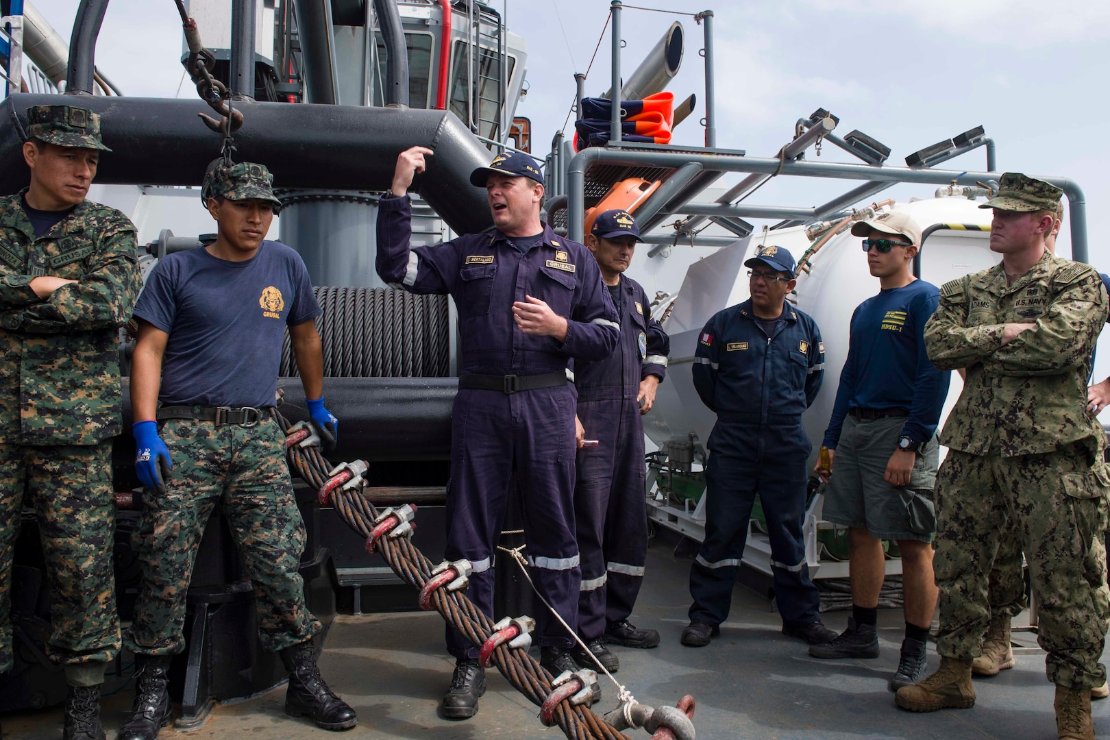 CALLAO, Peru (July 17, 2017) Captain Carlo Mario Bertalmio, commandant of the Peruvian vessel BAP Morales (RAS-180), center, gives a safety briefing to Peruvian and American Sailors before conducting a joint diving and salvage training exercise during UNITAS 2017. UNITAS is an annual, multi-national exercise that focuses on strengthening our existing regional partnerships and encourages establishing new relationships through the exchange of maritime mission-focused knowledge and expertise during multinational training operations. (U.S. Navy photo by Mass Communication Specialist 2nd Class Bill Dodge/Released)