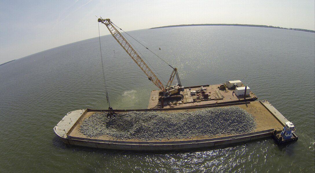 Granite rock, which is brought in by barge, is methodically placed in the Piankatank River near Gwynn’s Island in Mathews County Virginia. The rock is the basis for the newest, 25-acre oyster reef in the Chesapeake Bay Watershed. The Norfolk District, U.S. Army Corps of Engineers, is overseeing the more than $2 million sanctuary reef project in partnership with the Virginia Marine Resources Commission and the Nature Conservancy.   (U.S. Army photo/Patrick Bloodgood)