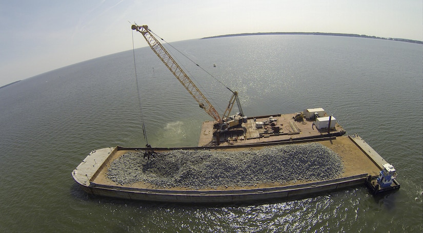 Granite rock, which is brought in by barge, is methodically placed in the Piankatank River near Gwynn’s Island in Mathews County Virginia. The rock is the basis for the newest, 25-acre oyster reef in the Chesapeake Bay Watershed. The Norfolk District, U.S. Army Corps of Engineers, is overseeing the more than $2 million sanctuary reef project in partnership with the Virginia Marine Resources Commission and the Nature Conservancy.   (U.S. Army photo/Patrick Bloodgood)