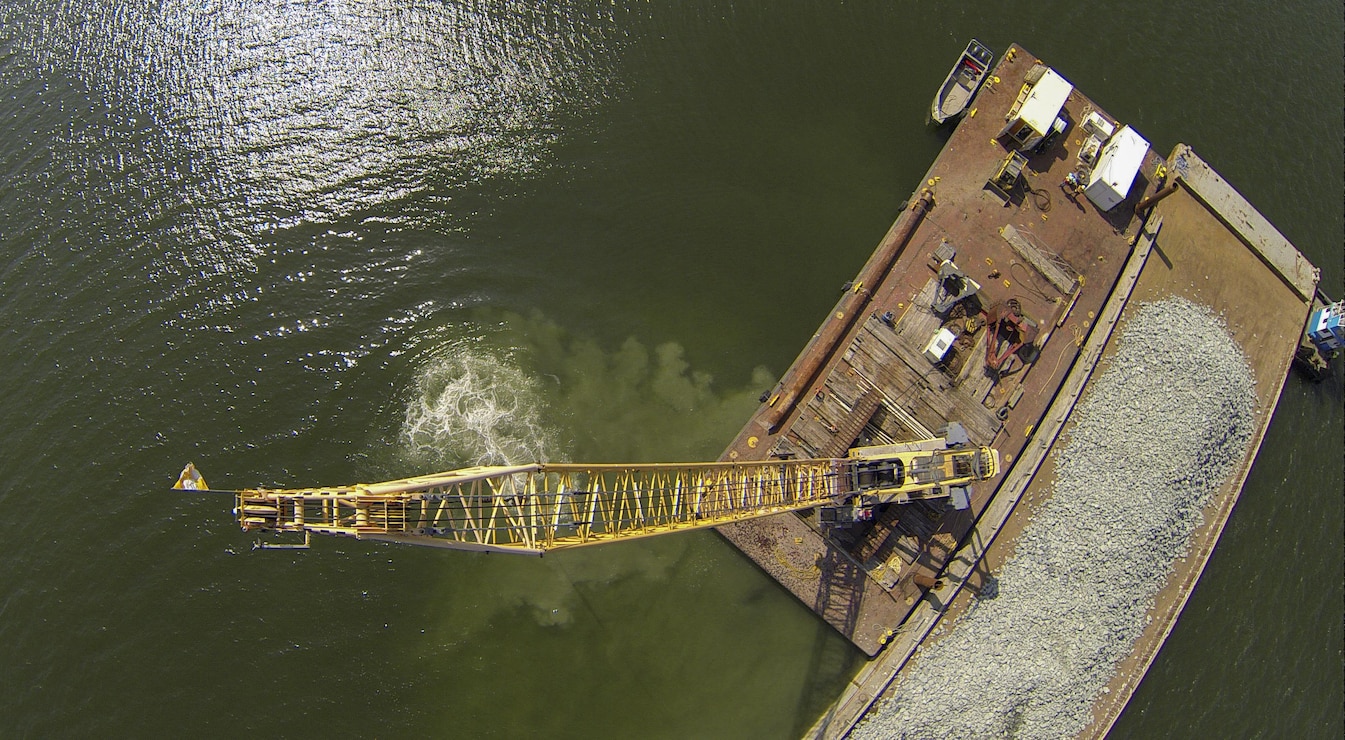 Granite rock, which is brought in by barge, is methodically placed in the Piankatank River near Gwynn’s Island in Mathews County Virginia. The rock is the basis for the newest, 25-acre oyster reef in the Chesapeake Bay Watershed. The Norfolk District, U.S. Army Corps of Engineers, is overseeing the more than $2 million sanctuary reef project in partnership with the Virginia Marine Resources Commission and the Nature Conservancy.   (U.S. Army photo/Patrick Bloodgood)