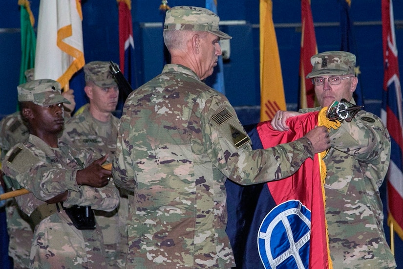 Maj. Gen. Victor J. Braden, commanding general of the 35th Infantry Division, and Command Sgt. Maj. Timothy Newton, senior enlisted advisor, uncase the division’s colors during the Task Force Spartan transfer of authority ceremony, at Camp Arifjan, Kuwait, July 13, 2017. The 35th Infantry Division assumed command of TF Spartan, part of Operation Spartan Shield, from the 29th Infantry Division. TF Spartan highlights the vital role played by Army National Guard and Army Reserve Soldiers in operations around the world.