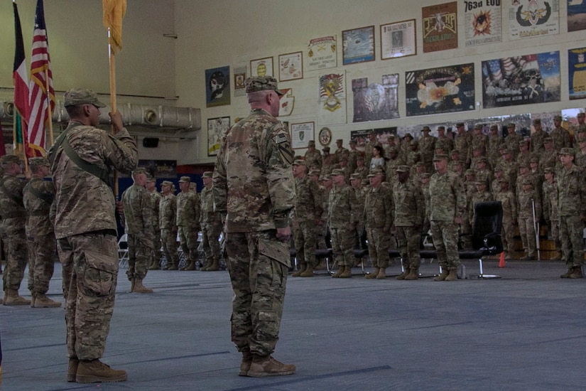 Soldiers and distinguished guests stand at attention in recognition of the national anthem during the Task Force Spartan transfer of authority ceremony, at Camp Arifjan, Kuwait, July 13, 2017. The 35th Infantry Division assumed command of Task Force Spartan, part of Operation Spartan Shield, from the 29th Infantry Division. TF Spartan highlights the vital role played by Army National Guard and Army Reserve Soldiers in operations around the world.