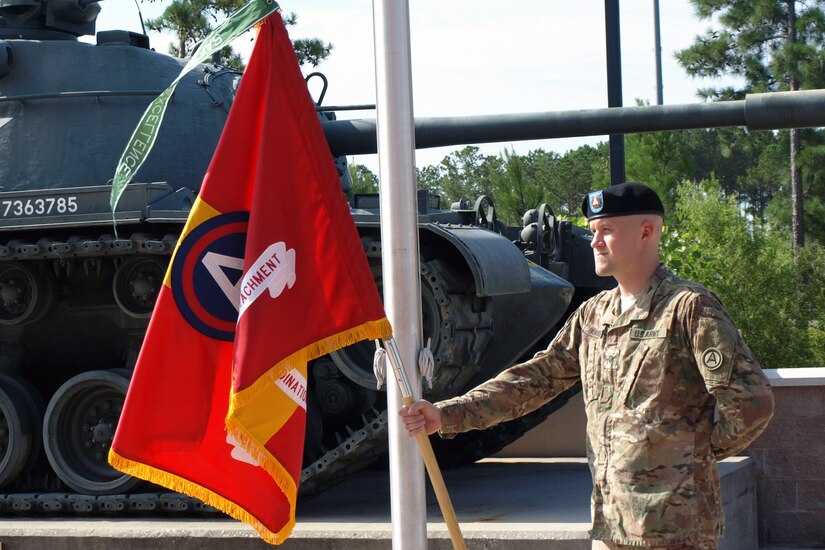 Spc. Adam Burkett, from the 4th Battlefield Coordination Detachment, U.S. Army Central, stands at parade rest while holding the 4th BCD's colors at an award presentation prior to the 4th BCD's change of command ceremony at Patton Hall on Shaw Air Force Base, S.C., July 11, 2017. Col. Samuel Saine, 4th BCD outgoing commander, relinquished his command of the detachment to Col. Geoffrey Adams, 4th BCD incoming commander.