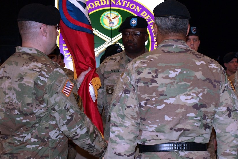 The 4th Battlefield Coordination Detachment, U.S. Army Central incoming Commander Col. Geoffrey Adams, left, passes the 4th BCD's colors to Sgt. Maj. Robert Clark, 4th BCD senior advisor to the commander, during the 4th BCD's change of command ceremony at Patton Hall on Shaw Air Force Base, S.C., July 11, 2017. Col. Samuel Saine, outgoing commander of the 4th BCD, relinquished his command of the detachment to Adams.