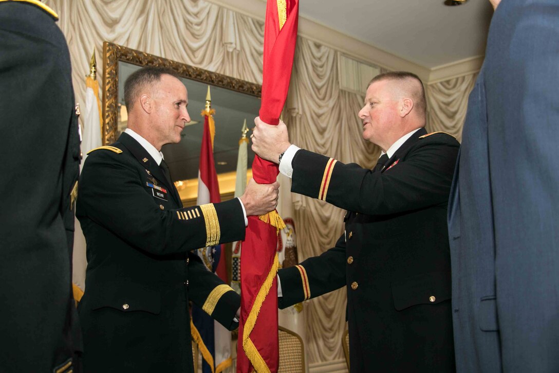 Maj. Gen. Wehr, Mississippi Valley Commander passes the command flag to Col. Bryan Sizemore, St. Louis District's 52nd commander during a change of command ceremony, June 30, 2017.