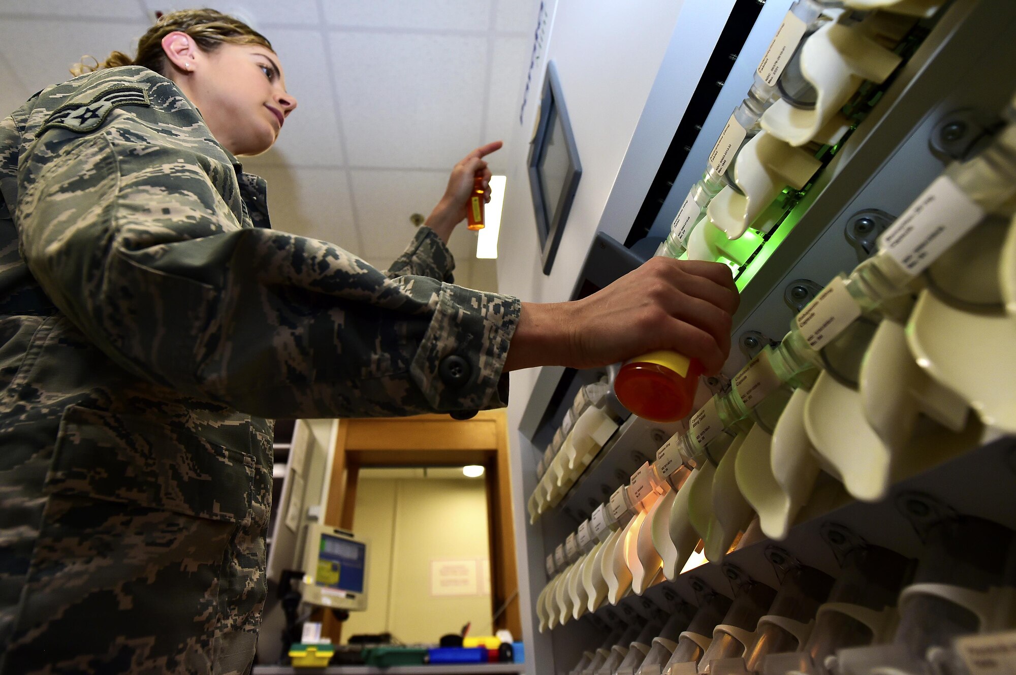 U.S. Air Force Senior Airman Lesley Colletta, 86th Medical Squadron pharmacy technician, uses a Parata Mini automatic pill-dispensing machine to fill a prescription at Landstuhl Regional Medical Center, Germany, July 13, 2017. Colletta caught a medical error in a medicine for an infant in the neonatal intensive care unit and because of this received recognition as a Trusted Care Hero. (U.S. Air Force photo by Staff Sgt. Jonathan Bass)