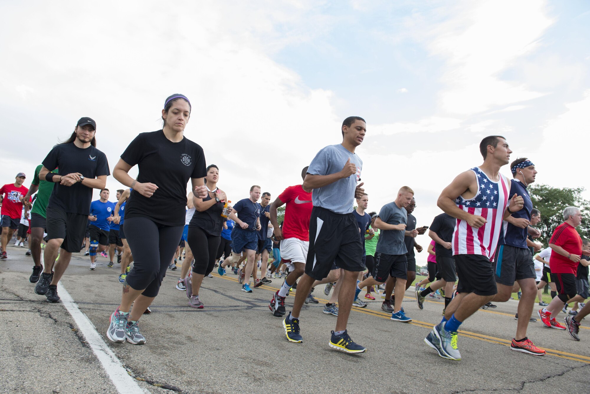 Team Wright-Patt employees run during the Run for the Fallen at Wright-Patterson Air Force Base, Ohio, September 9, 2016.  The Run for the Fallen provides an opportunity to remember and honor those who lost their lives and recognize those who continue to defend the nation. (U.S. Air Force photo by Michelle Gigante)
