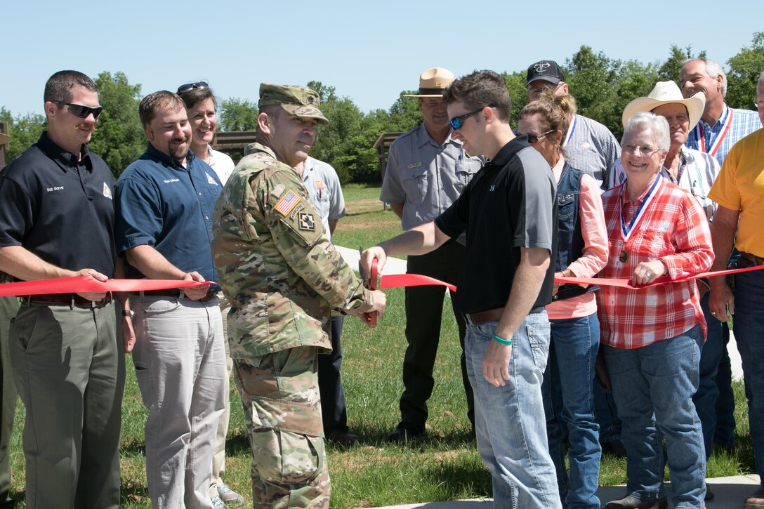 St. Louis District Deputy Commander Lt. Col. Ramon Mejia and Todd Shoemate, Mark Twain Lake FOREST Council vice president, cut a ribbon during a ribbon-cutting ceremony, May 31, 2017, for Mark Twain Lake's new archery range. The archery range has an ADA-compliant event target range and a 15-station archery trail. Completion of this range and trail was accomplished with a Handshake Partnership Program Grant, as well as donations of time, materials, and labor.