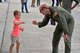 Capt. Michael Hart fist-bumps a young child at the Royal International Air Tattoo in Fairford, U.K.  A crew from the 315th Airlift Wing participated in the three-day airshow.  The airshow celebrated the 70th anniversary of the U.S. Air Force. (U.S. Air Force Photo by Maj. Wayne Capps)