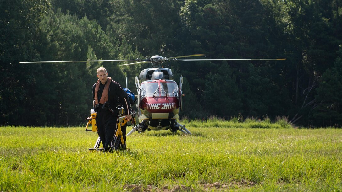 Scott McClain, Nightingale Regional Air Ambulance paramedic, responds to an aircraft mishap exercise at Joint Base Langley-Eustis, Va., July 13, 2017. The exercise included a simulated downed U.S. Navy H-60 Seahawk assigned to Norfolk Naval station. The decision to integrate a Navy aircraft into the exercise scenario was based on their frequency at Fort Eustis’ Felker Army Airfield. (U.S. Air force photo/Staff Sgt. Areca T. Bell)